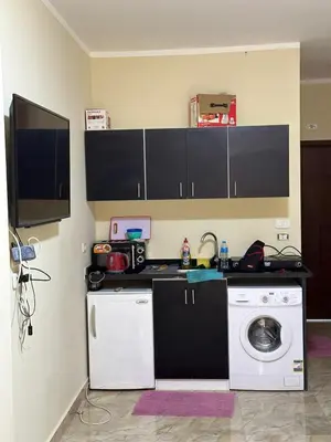 a kitchen with a washing machine and a washer at Magawish District in Hurghada