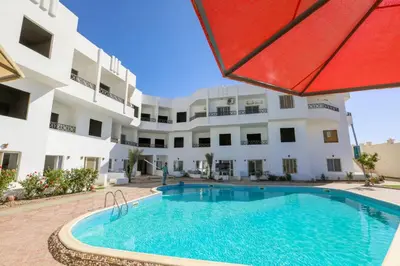 a swimming pool in front of a building at La bonita compound for rent in Hurghada