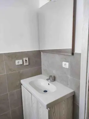a bathroom with a white sink and a mirror at Azzurra two-bedrooms apartment at Sahl Hasheesh in Hurghada