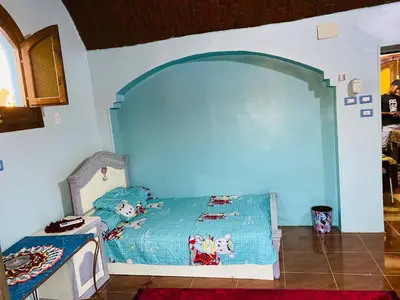 a childs bedroom with a blue bed in a room at Malika nubian house in Aswan