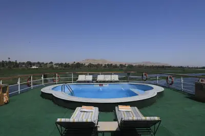 a swimming pool on a boat with chairs around it at Iberotel Amara Nile Cruise - Every Thursday from Luxor for 07 & 04 Nights - Every Monday From Aswan for 03 Nights in Luxor
