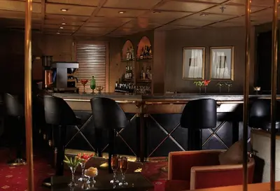 a bar in a restaurant with black chairs at Iberotel Amara Nile Cruise - Every Thursday from Luxor for 07 & 04 Nights - Every Monday From Aswan for 03 Nights in Luxor
