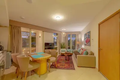 a living room with a table and a couch at Fresh & Modern 1BR in El Gouna. Mangroovy Pool & Beach in Hurghada