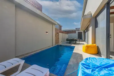 a swimming pool in the backyard of a house at Modern & Comfy 2BR in Bali, El Gouna. Private Patio & Pool in Hurghada