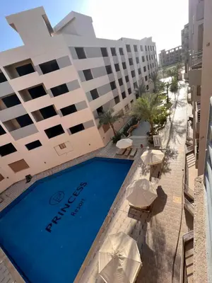 a swimming pool in front of a hotel at Princess Resort (Rayan) in Hurghada