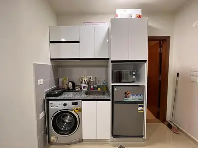 a small kitchen with a washing machine and a washer at Princess Resort (Rayan) in Hurghada