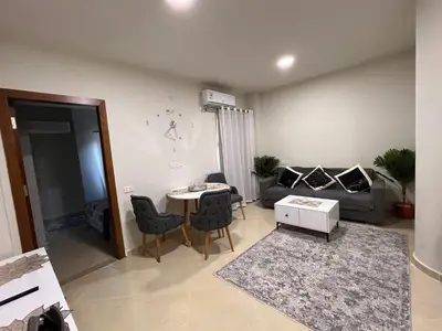 a living room with a table and a couch at Princess Resort (Rayan) in Hurghada