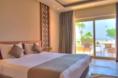 a bedroom with a large bed and a balcony at Jasmine Palace Resort in Hurghada