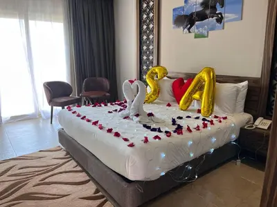 a large bed with two swans on top of it at Jasmine Palace Resort in Hurghada