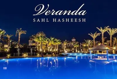 a resort with a large swimming pool at night at veranda sahl hasheesh in Hurghada