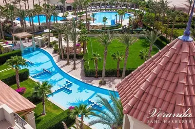 an aerial view of a resort pool with palm trees at veranda sahl hasheesh in Hurghada