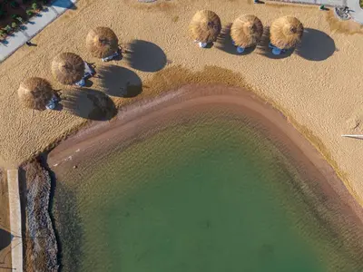 an overhead view of a beach with a body of water at Creek Hotel and Residences El Gouna in Hurghada