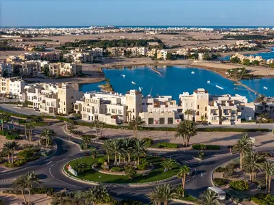 an aerial view of a city with houses and a lake at Creek Hotel and Residences El Gouna in Hurghada