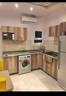 a kitchen with a dishwasher and a washer in it at Sea view Apartment in Hurghada