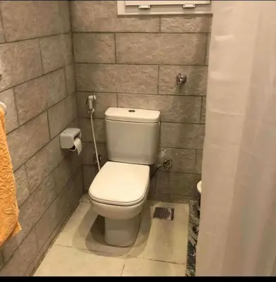 a bathroom with a toilet in a brick wall at Sea view Apartment in Hurghada