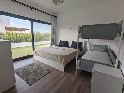 a bedroom with two bunk beds and a large window at Somabay Retreat 2BR Apartment in Hurghada