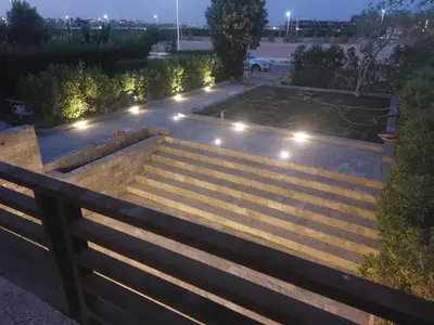 a garden with stairs and lights at night at SOLA INN Hotel Hurghada in Hurghada