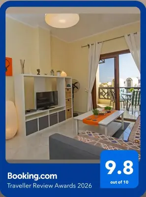 a living room with a tv and a table at Buki-Gravity-Homes, Ap No2, seaview , HEATED pool, 5 star resort Gravity Sahl Hasheesh-FOR GUESTS WITH NONEGYPTIAN PASSPORTS in Hurghada