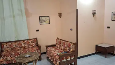 a living room with a couch and a table at West Bank Guest House in Luxor