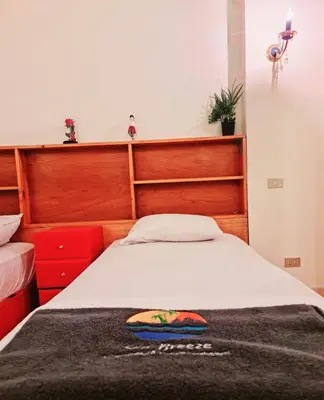 a bedroom with a large bed with a wooden headboard at West golf 2bedroom in Hurghada