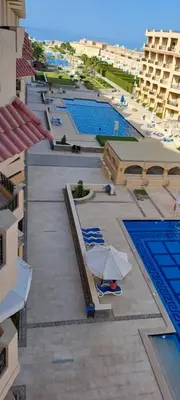 an overhead view of a swimming pool with lounge chairs at selena bay resort hurgada in Hurghada