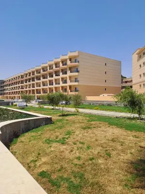 a large building with a grass field in front of it at selena bay resort hurgada in Hurghada