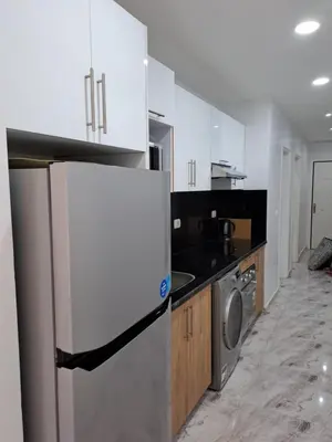 a white kitchen with a refrigerator and a stove at selena bay resort hurgada in Hurghada