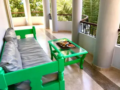 a room with a bed and a tray of food on a table at Villa Elkoumy Apartments in Luxor
