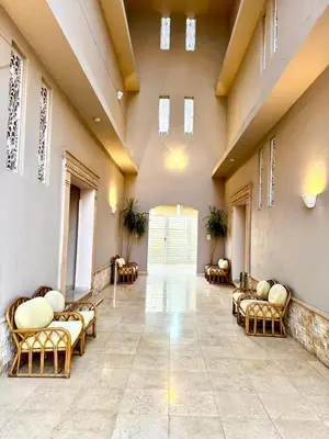 a hospital hallway with chairs and a large door at Royal Nile Villa - Nile View Apartment 1 in Luxor