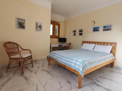 a bedroom with a bed and a chair and a desk at Villa Bauhaus in Al Aqālitah