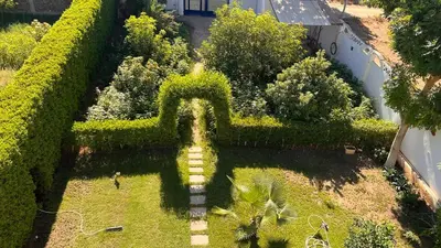 an aerial view of a garden with a fountain at Villa Bauhaus in Al Aqālitah
