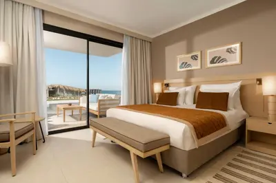 a bedroom with a bed and a view of the ocean at JAZ Elite Amara in Marsa Alam City