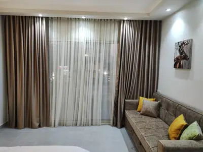 a living room with a couch and a large window at scandic resort in Hurghada