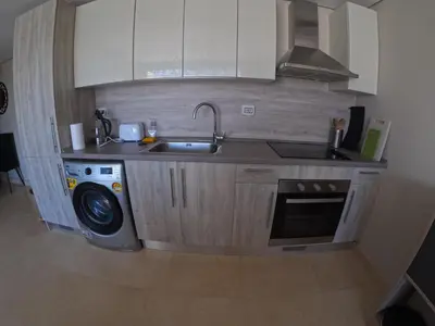 a kitchen with a sink and a washing machine at El Gouna Mangroovy 2Bd - M10 in El Gouna