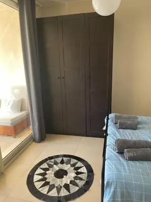 a bedroom with a bed and a rug on the floor at Mangroovy- Sensational 1BR Sea & Kite view in Hurghada