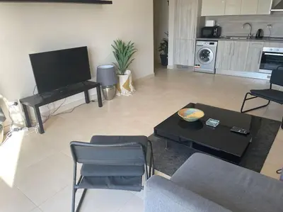 a living room with a couch and a table at Mangroovy- Sensational 1BR Sea & Kite view in Hurghada