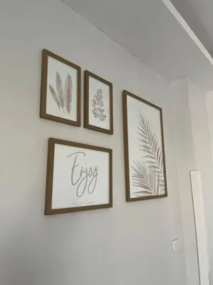 four framed prints of leaves on a white wall at Royal Nile Villa - Luxury Nile View Apartment 1 in Luxor