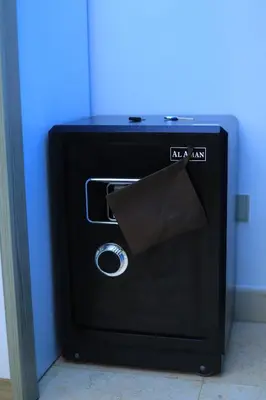 a black safe with a paper inside of it at New Marina Hurghada Suite in Hurghada