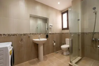 a bathroom with a toilet and a sink and a shower at one bedroom apartment in Hurghada