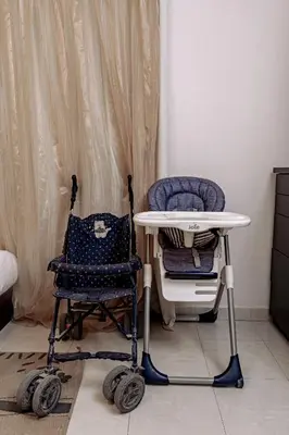 a high chair and a high table in a room at one bedroom apartment in Hurghada