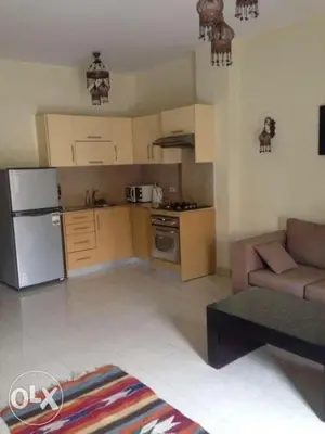 a living room with a couch and a kitchen at Baron palace 41 in Hurghada