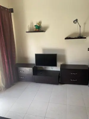a living room with a flat screen tv on a cabinet at Baron palace 41 in Hurghada