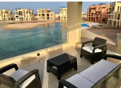 a balcony with chairs and a view of a pool at Emos Villa in Hurghada