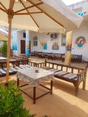 a room with benches and a table in a building at ANA-KA Guest house in Aswan