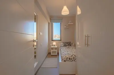 a hallway leading to a bedroom with a bed and a window at Apartment in Tawila ElGouna The Butterfly in Hurghada