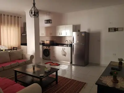 a living room with a couch and a refrigerator at شقه جديده بالكامل في قلب الغردقه in Hurghada