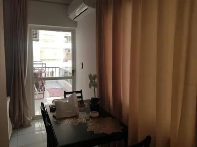 a dining room table with a view of a balcony at شقه جديده بالكامل في قلب الغردقه in Hurghada