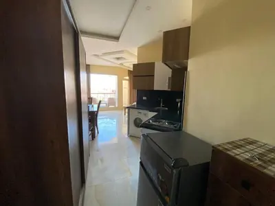 a small kitchen with a stove and a refrigerator at ديزرت بيرل in Hurghada