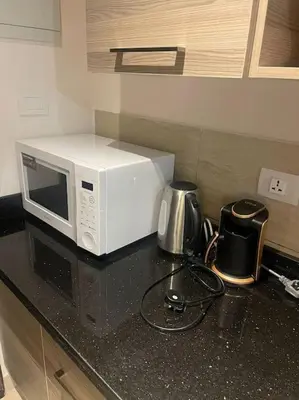 a microwave sitting on top of a kitchen counter at 3316- Awesome Garden view studio in Al Dau Heights in Hurghada