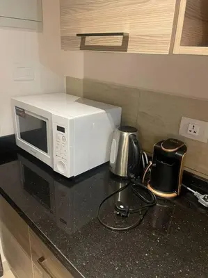 a microwave sitting on top of a kitchen counter at 3316- Awesome Garden view studio in Al Dau Heights in Hurghada